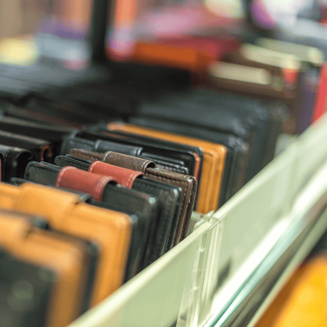 A variety of leather wallets in different colors displayed for selection.