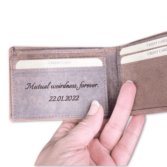 A leather wallet with engraved message on inside flap.